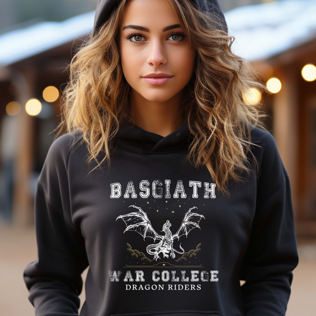 Young woman wih long hair wearing a black dragon rider Basgiath War College hoodie for fantasy book readers of Fourth Wing, Iron Flame, and Onyx Storm created by graphic apparel company Midnight Gypsy Designs as part of their bookish merch collection.