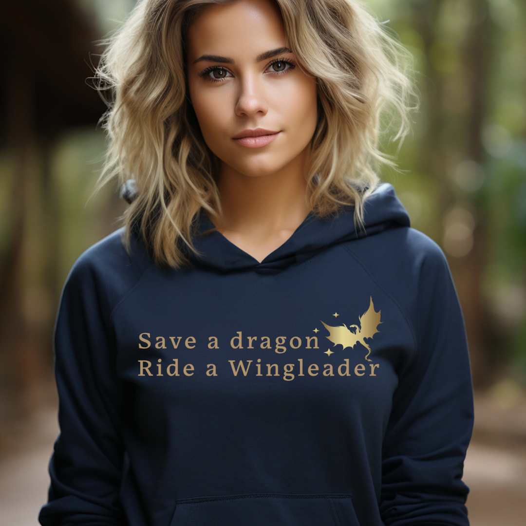 Young woman with wavy blonde hair standing outside wearing a navy Fourth Wing shirt that says Save a Dragon Ride a Wingleader with a dragon and stars created by graphic apparel company Midnight Gypsy Designs as part of its bookish merch collection for fantasy book readers. Perfect dragon riders shirt, Xaden Riorson shirt, Iron Flame shirt and Onyx Storm shirt.
