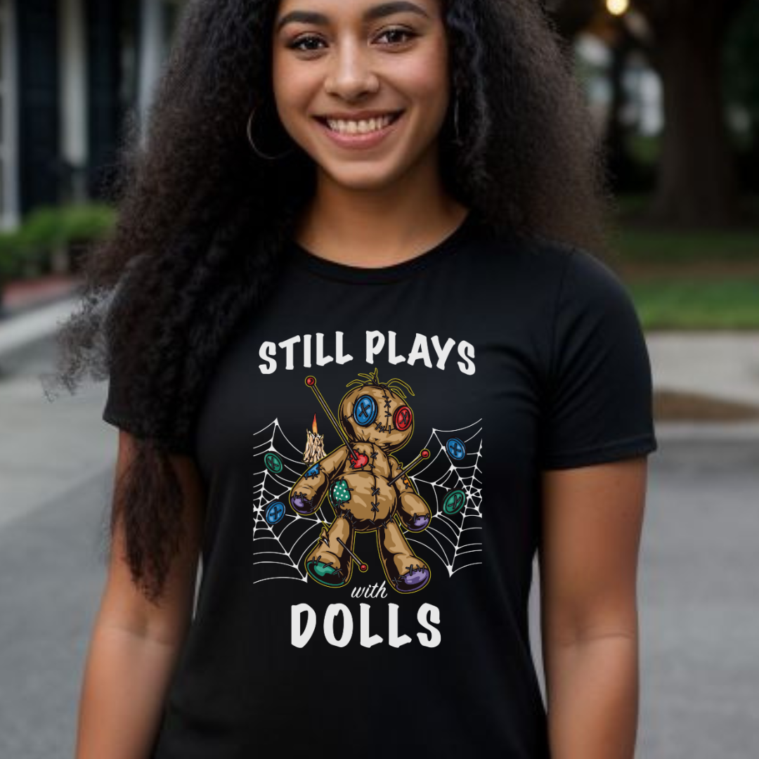 Young woman with long black hair smiling while standing in New Orleans wearing a Still Plays With Dolls VooDoo shirt created by clothing apparel company Midnight Gypsy Designs.