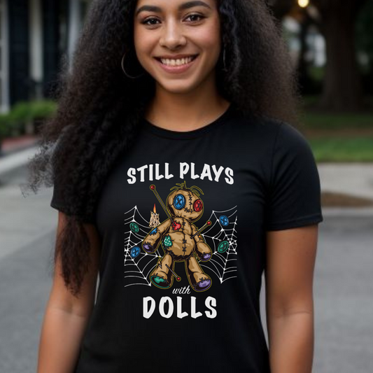 Young woman with long black hair smiling while standing in New Orleans wearing a Still Plays With Dolls VooDoo shirt created by clothing apparel company Midnight Gypsy Designs.