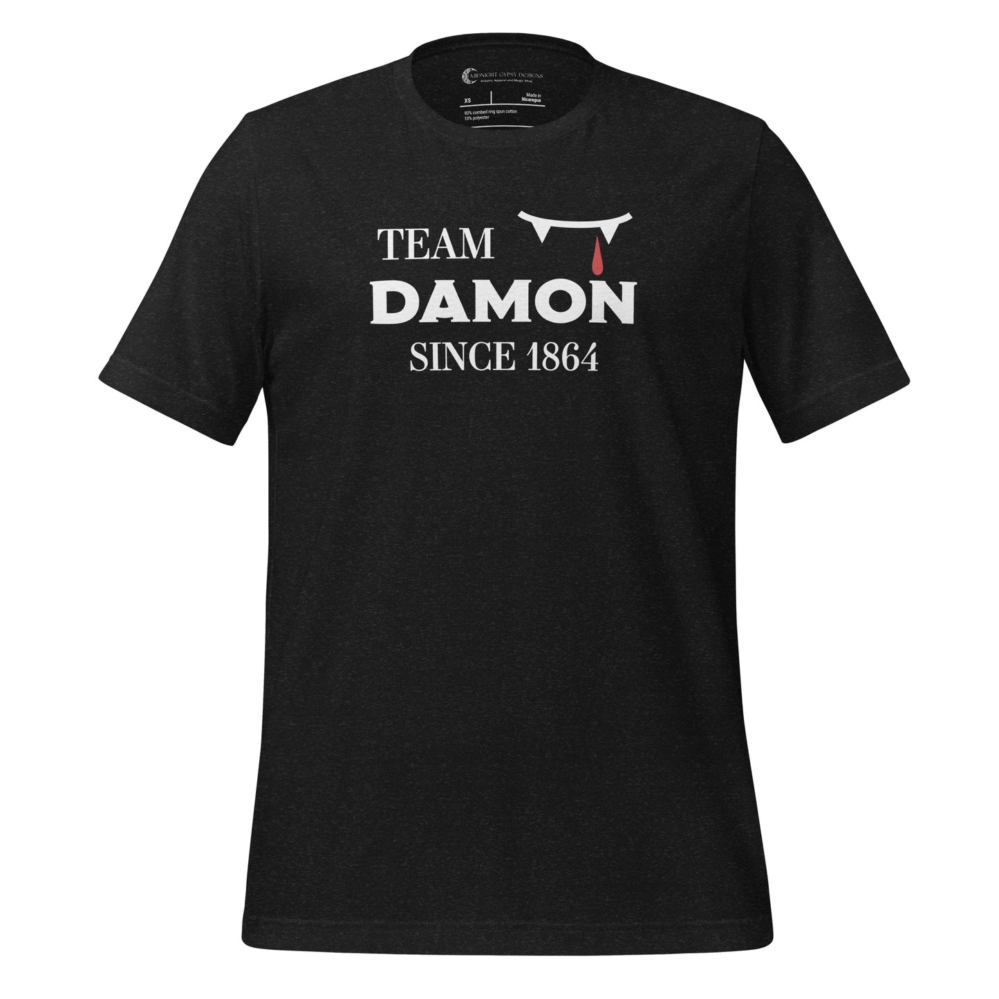 Heather black The Vampire Diaries Team Damon Since 1864 shirt with fangs and blood drip created by graphic apparel company Midnight Gypsy Designs. Perfect Team Damon shirt, Damon Salvatore shirt, the Vampire Diaries shirt, cute vampire shirt, team Damon apparel, Salvatore Brothers shirt, team Damon t-shirt, Mystic Falls shirt, and Mystic Falls t-shirt for fans of The Vampire Diaries!