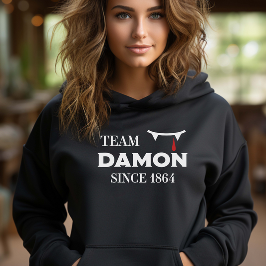 Team Damon Since 1864 hoodie with vampire teeth and blood drip created by graphic apparel company Midnight Gypsy Designs as part of their The Vampire Diaries mech collection. Perfect Vampire Diaries shirt, team Damon shirt, team Damon hoodie, Damon Salvatore hoodie, and Mystic Falls hoodie!