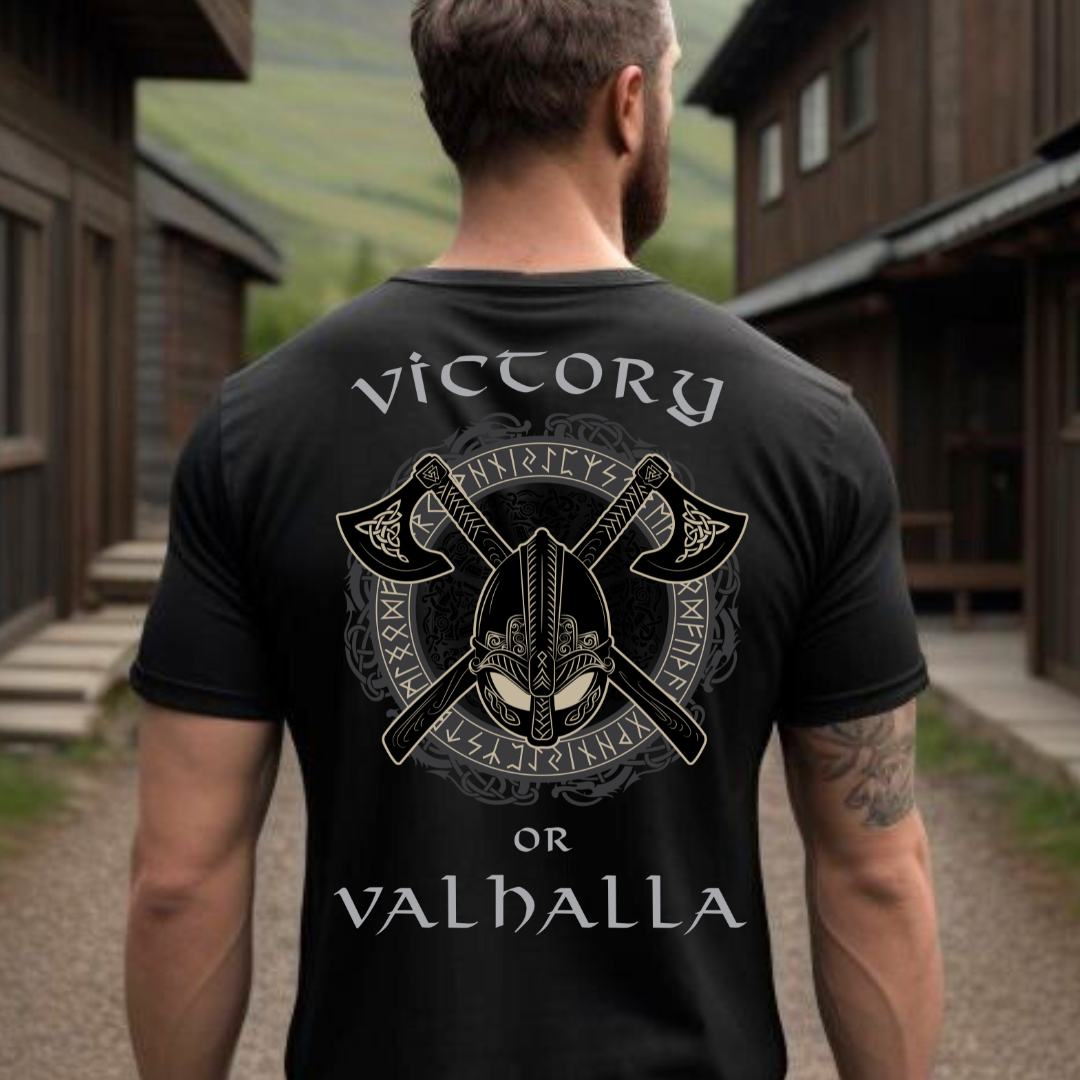 Man with a beard standing outside wearing a Victory or Valhalla Viking Warrior shirt with Norse runes and Viking axes created by graphic apparel shop Midnight Gypsy Designs as part of their Viking clothing line collection.