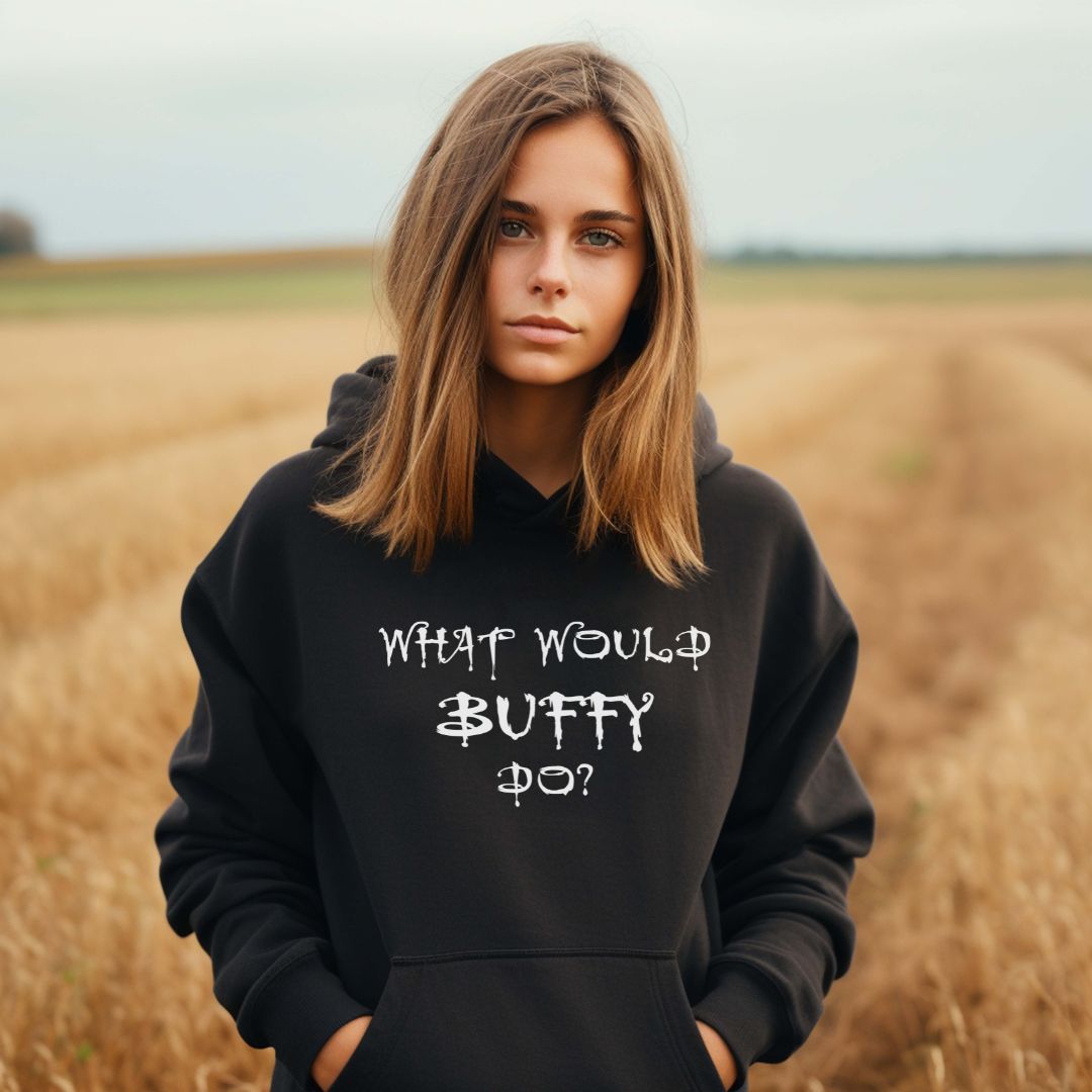 Young woman with long hair standing in a wheat field wearing a black What Would Buffy Do shirt for fans of Buffy the Vampire Slayer TV show created by graphic apparel shop Midnight Gypsy Designs as part of their Buffy The Vampire Slayer apparel line. Perfect Buffy the Vampire Slayer shirt, Buffy Summers shirt, cute vampire shirt, Buffy Summers hoodie cute Buffy hoodie, cute Buffy shirt, What Would Buffy Do shirt, halloween vampire hoodie, and cute Halloween shirt.