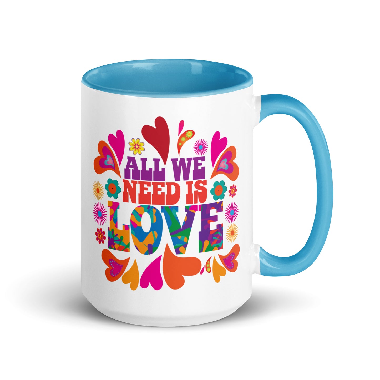 All we need is love coffee mug with blue handle and colorful hearts with 1960s hippie style created by clothing apparel company Midnight Gypsy Designs. Perfect mental health awareness mug, Valentine's Day mug, peace mug, flower child mug, and cute kindness mug.