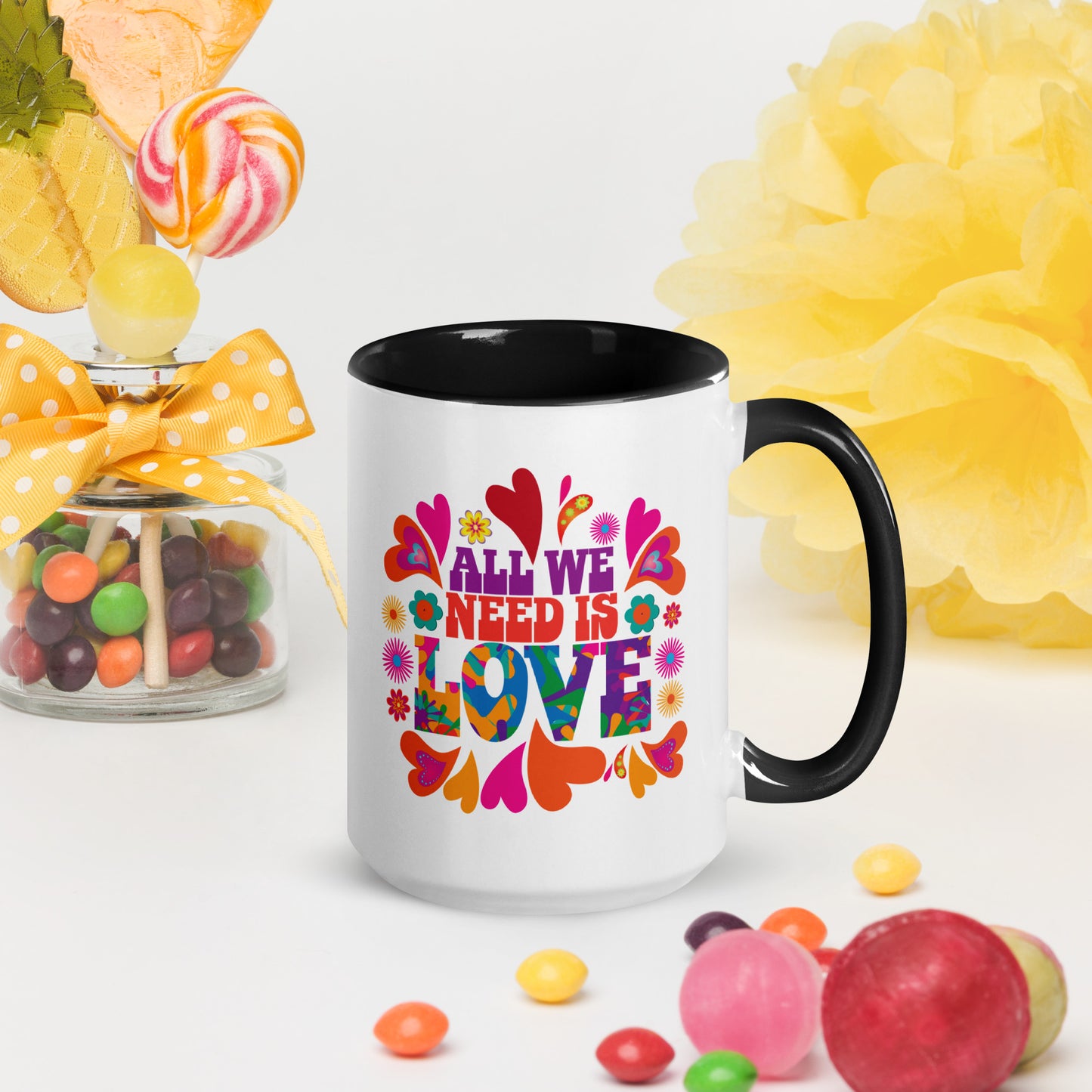 All we need is love coffee mug with black handle and hearts with 1960s hippie style created by clothing apparel company Midnight Gypsy Designs. Perfect mental health awareness mug, Valentine's Day mug, peace mug, flower child mug, and cute kindness mug.