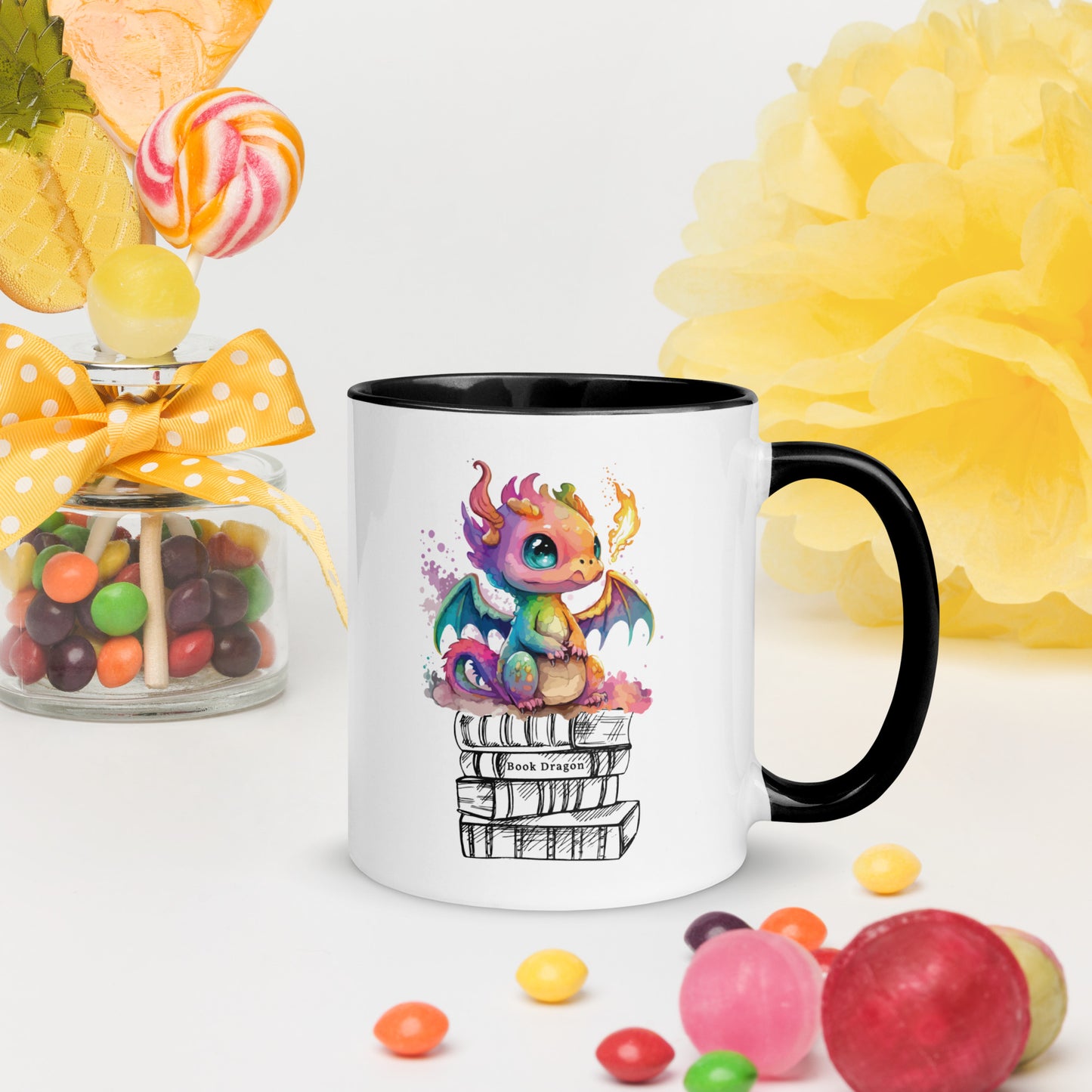 Cute black and white book dragon mug with a colorful dragon breathing fire while sitting on top of a stack of books created by graphic apparel shop Midnight Gypsy Designs as part of their fantasy book merch collection for fantasy readers. Perfect mug for readers, bookish mug, book merch, and book dragon coffee mug!