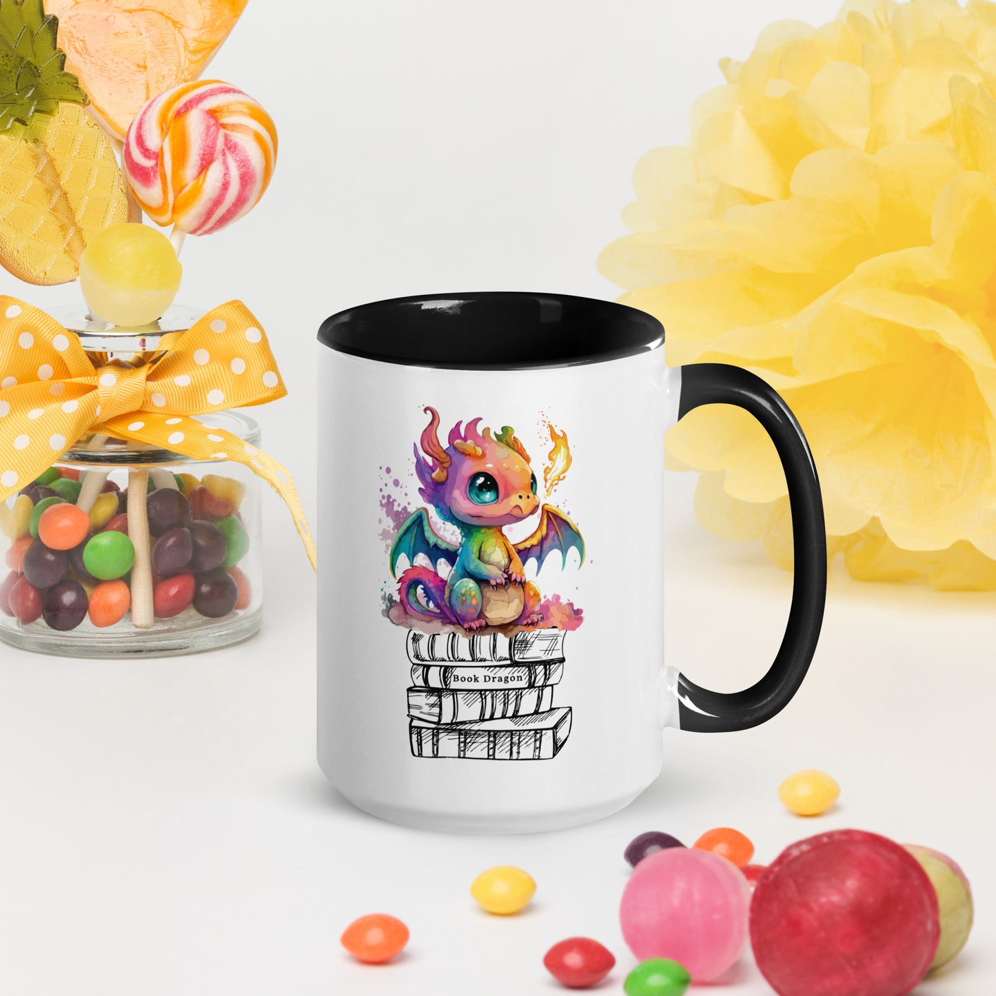 Cute black and white book dragon mug with a colorful dragon breathing fire while sitting on top of a stack of books created by graphic apparel shop Midnight Gypsy Designs as part of their fantasy book merch collection for fantasy readers. Perfect mug for readers, bookish mug, book merch, and book dragon coffee mug!
