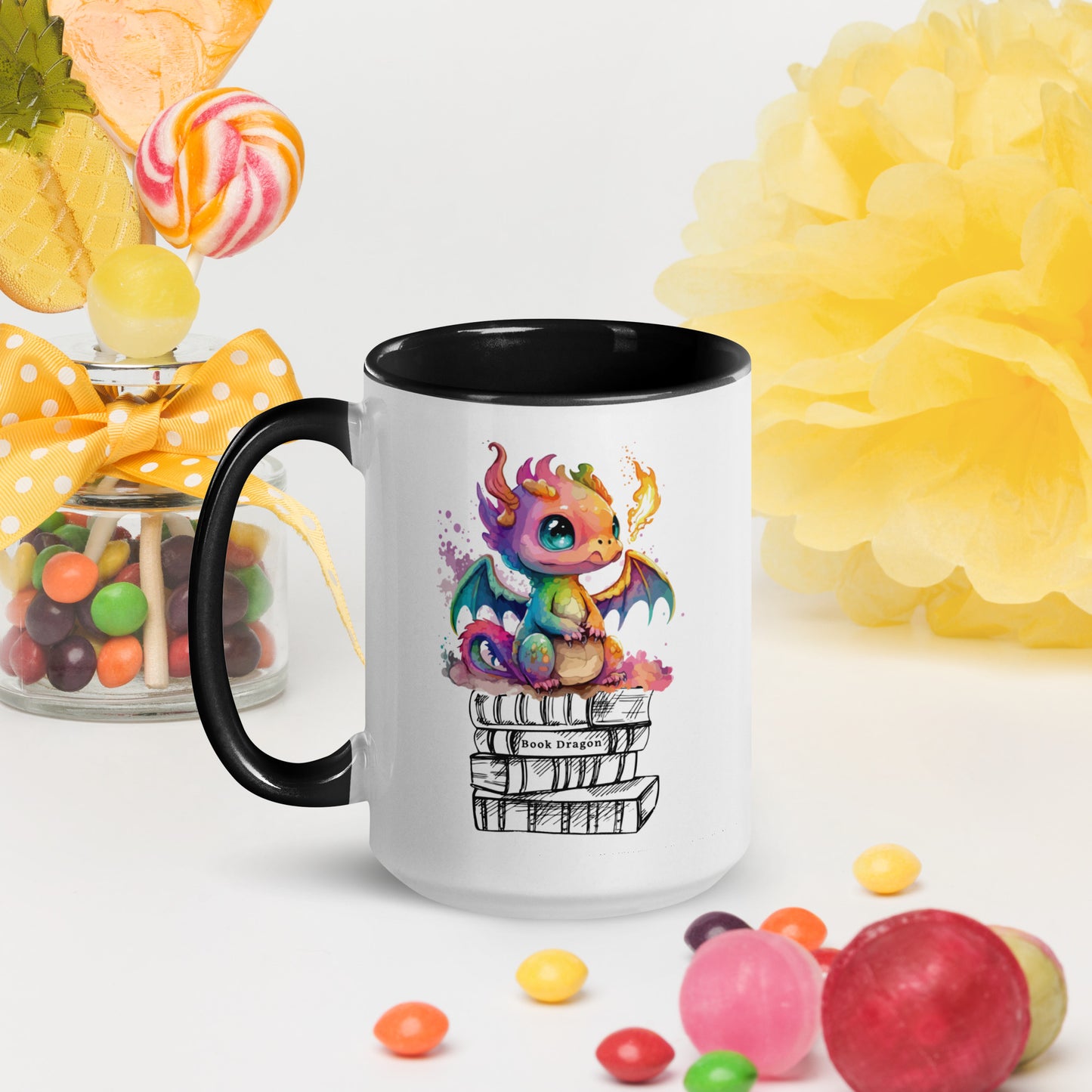 Cute black and white book dragon mug with a colorful dragon breathing fire while sitting on top of a stack of books created by graphic apparel shop Midnight Gypsy Designs as part of their fantasy book merch collection for fantasy readers. Perfect mug for readers, bookish mug, book merch, and book dragon coffee mug!