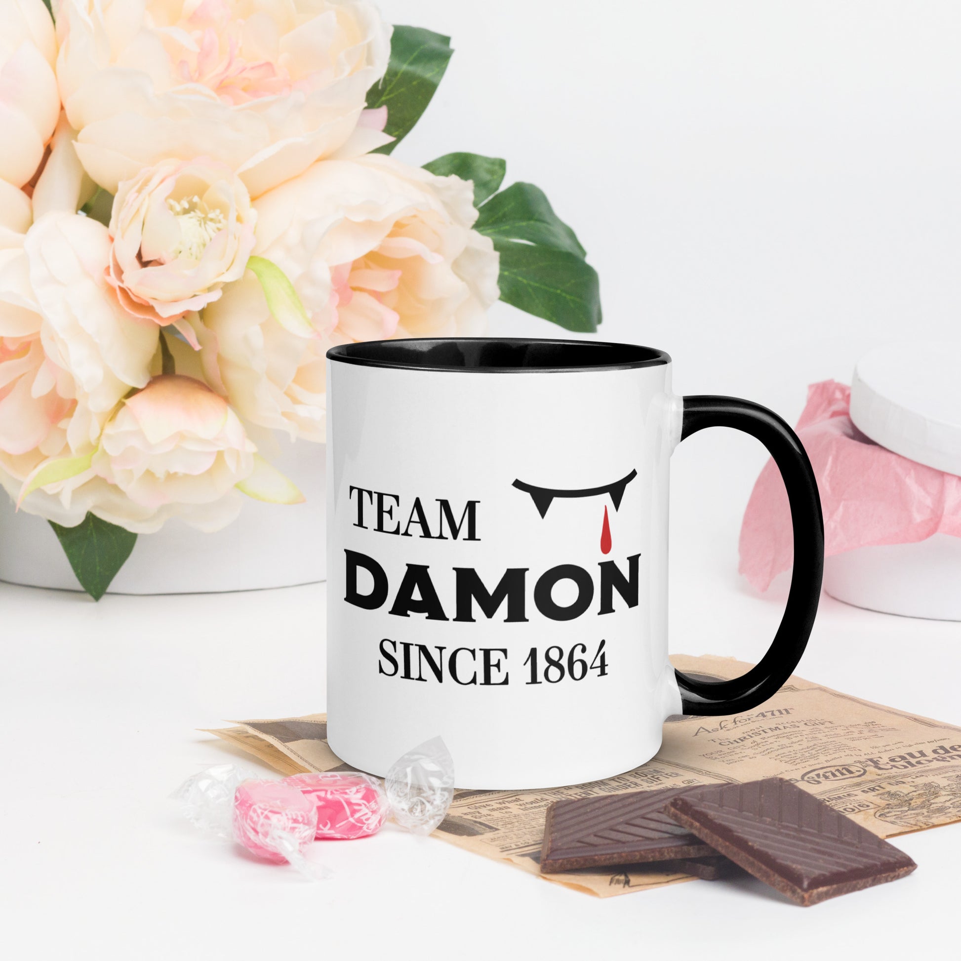 Team Damon Since 1864 mug with vampire teeth and blood drip created by graphic apparel company Midnight Gypsy Designs as part of their The Vampire Diaries mech collection. Perfect Vampire Diaries mug, team Damon mug, Damon Salvatore coffee mug, and Mystic Falls mug!