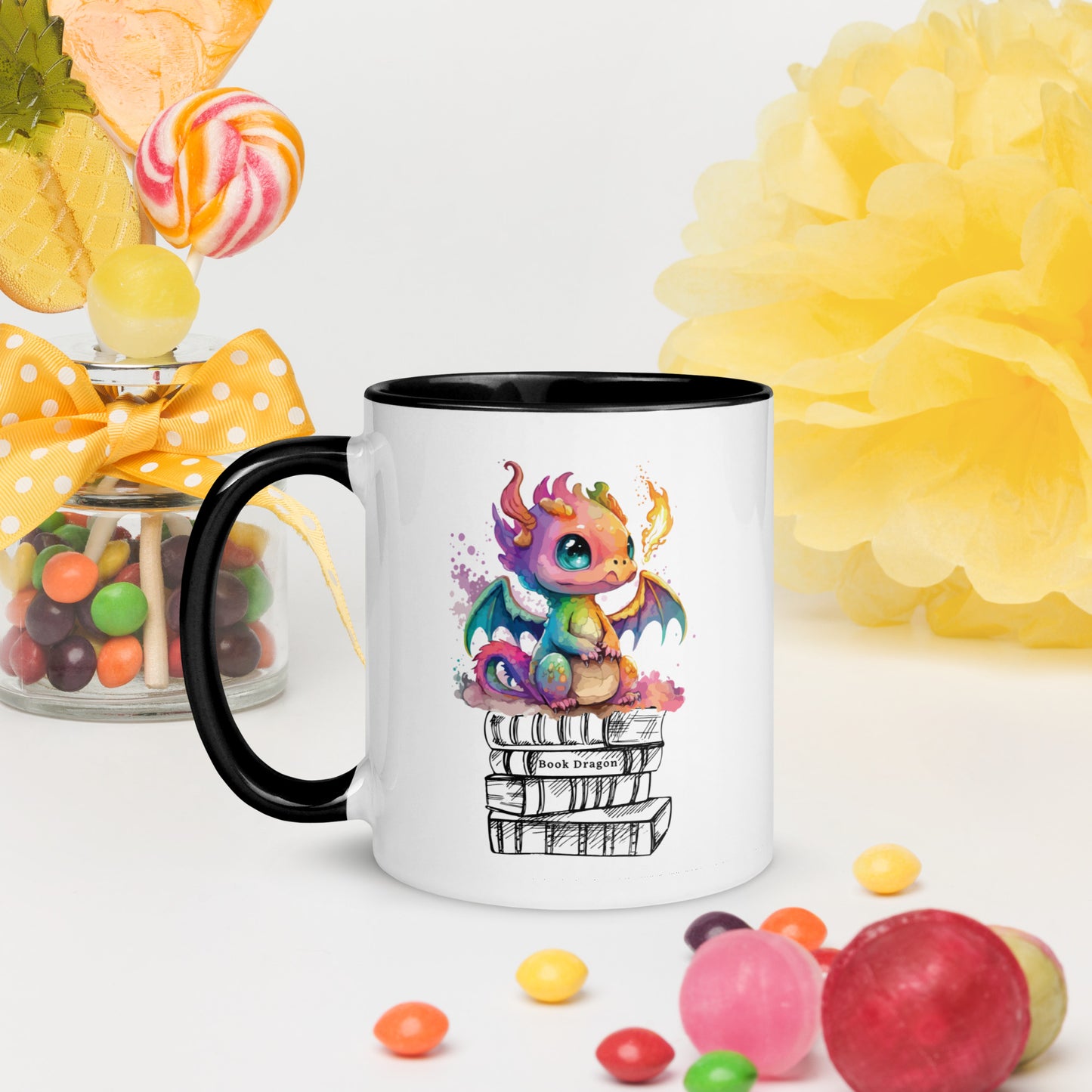 Cute black and white book dragon mug with a colorful dragon breathing fire while sitting on top of a stack of books created by graphic apparel shop Midnight Gypsy Designs as part of their fantasy book merch collection for fantasy readers. Perfect mug for readers, bookish mug, book merch, and book dragon coffee mug!