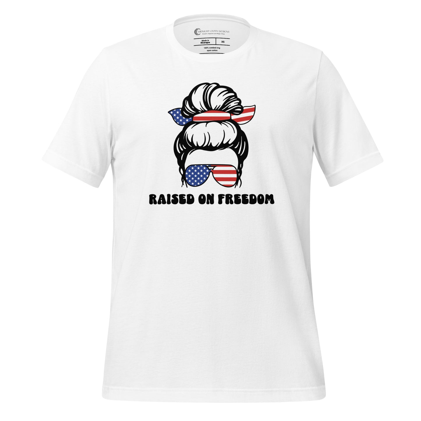 White Raised on Freedom shirt with graphic of a woman with an American flag hair tie and sunglasses created by graphic apparel company Midnight Gypsy Designs as part of their patriotic apparel collection. Perfect USA patriotic shirt, All American Girl shirt, girl power shirt, American pride shirt, USA shirt, USA flag shirt, womens patriotic shirt, Fourth of July shirt, Patriotic pride shirt, American flag shirt, Independence Day shirt, & American girl shirt.