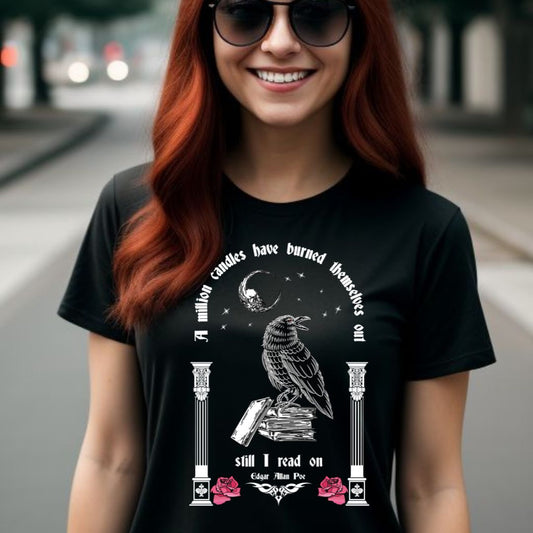 Young woman with long red hair wearing black sunglasses and black t-shirt with words A Million Candles Have Burned Themselves Out Still I Read On by Edgar Allan Poe with black raven on stack of book, moon, stars, and pink roses from apparel shop Midnight Gypsy Designs.