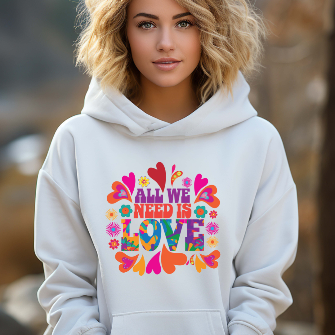 Young woman with blonde hair wearing a white All We Need Is Love hoodie with colorful flowers and hearts by apparel shop Midnight Gypsy Designs for mental health awareness. Vintage 1960s hippie hoodie.