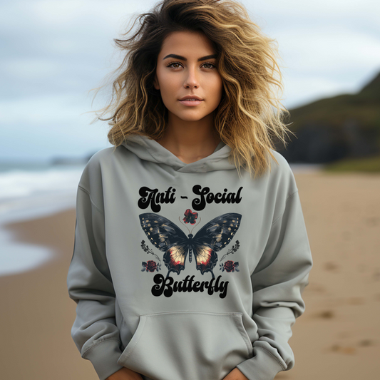 Young woman with long hair at the beach wearing an Anti-Social Butterfly hoodie created by apparel shop Midnight Gypsy Designs.