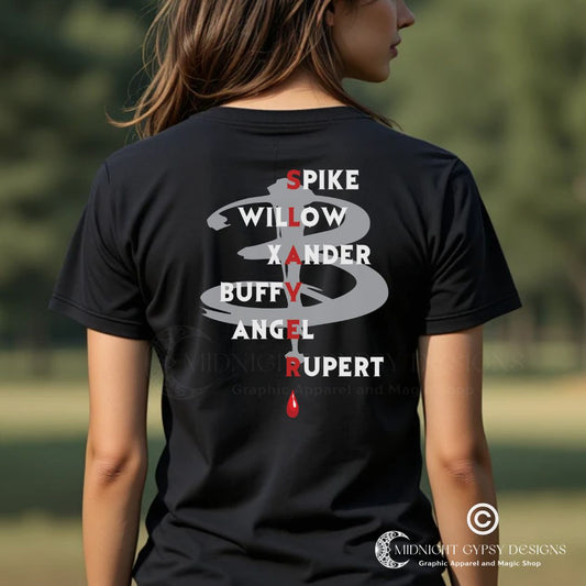 Young woman with brown hair standing outside wearing a Scooby Gang Buffy the Vampire Slayer T-shirt with the character names Spike, Willow, Xander, Buffy, Angel, and Rupert on the back with the word Slayer in red and a red blood drip created by fandom graphic apparel company Midnight Gypsy Designs as part of their Buffy the Vampire Slayer clothing line.