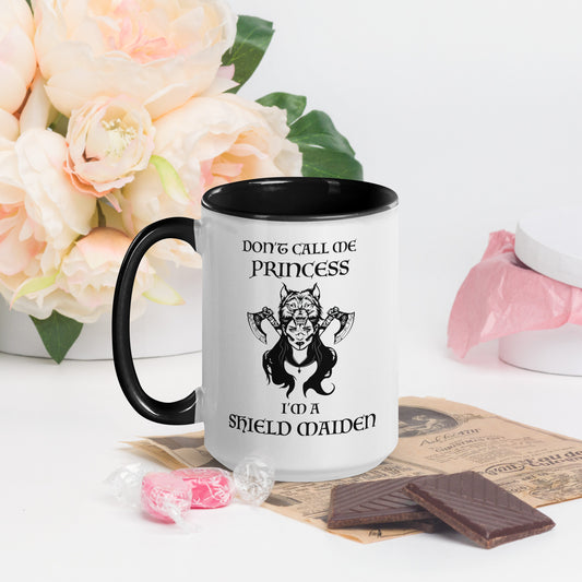 Black and white ceramic coffee mug with lettering that says Don't Call Me Princess I'm a Shield Maiden with a female Viking Warrior with Norse Viking axes and a wolf created by apparel shop Midnight Gypsy Designs.