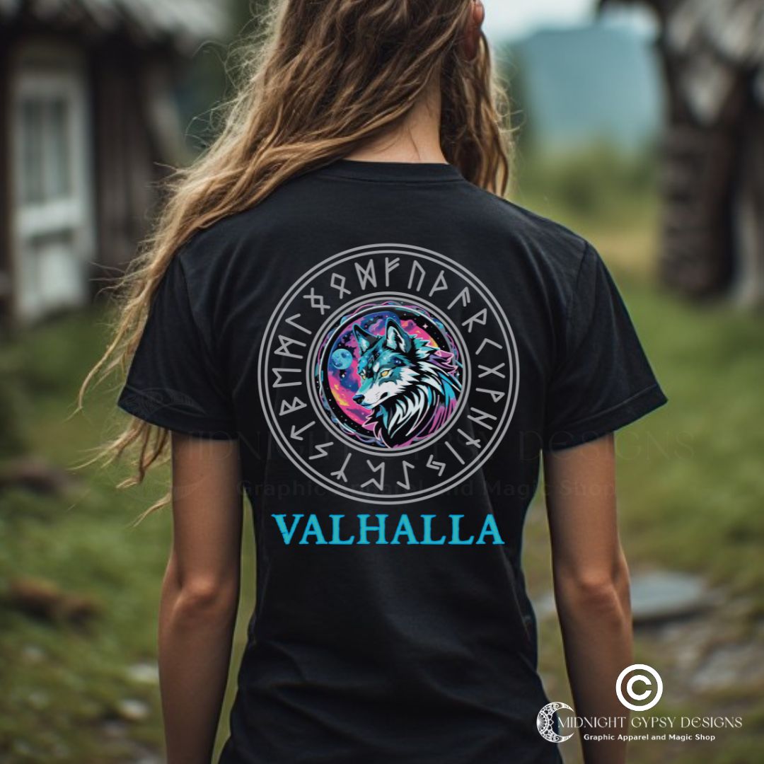 Young woman wearing a black Fenrir Wolf Shirt for women with Valhalla in blue at the bottom and the Viking rune compass while standing outside in Norway created by graphic apparel company Midnight Gypsy Designs as part of their Norse Viking t-shirt clothing line. Perfect Valhalla shirt for women, Norse Viking Warrior t-shirt, Shield-Maiden Warrior shirt, pagan shirt for women, and Viking Shield-Maiden shirt.