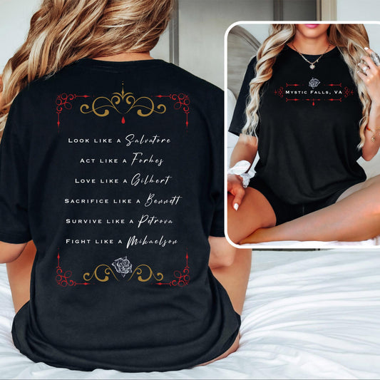 Young woman with long blonde hair wearing a black Mystic Falls t-shirt from The Vampire Diaries that says look like a Salvatore, Act like a Forbes, Love like a Gilbert, Sacrifice like a Bennett, survive like a Petrova, and fight like a Mikaelson with a rose and red blood drip created by clothing apparel shop Midnight Gypsy Designs.