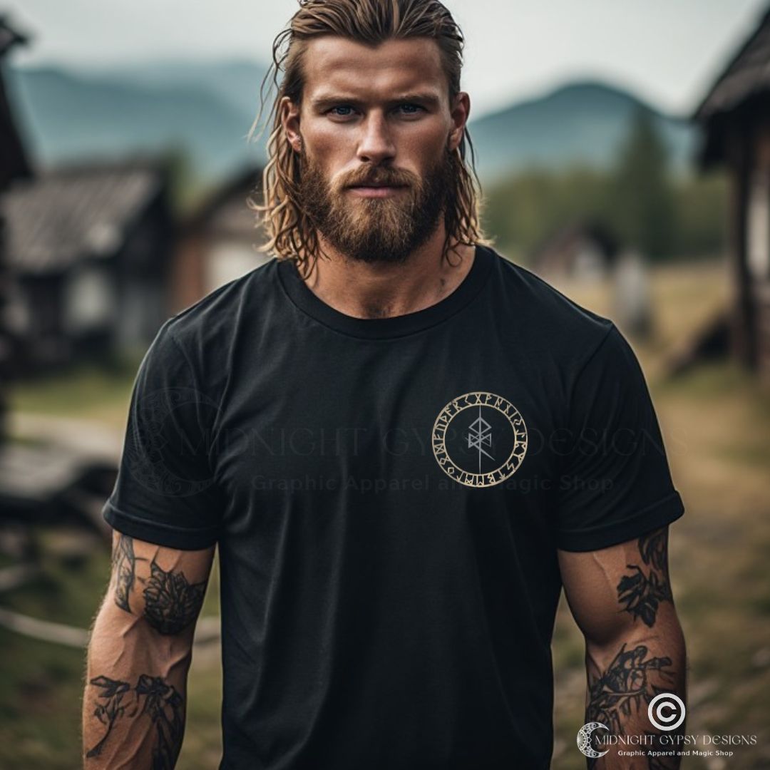 A young muscular Viking man wearing a  black Valhalla Viking Warrior Shirt that says Valhalla Only the Worthy with a Viking skull and Valknut symbol on the back and the Odin Norse rune on the front in the center of the Viking compass vegvisir created by Viking apparel company Midnight Gypsy Designs as part of their Viking Apparel clothing line. Perfect Odin God of War shirt, black Vikings shirt, Viking Odin shirt, Valhalla warrior shirt, Norse Viking tee, Norse mythology t-shirt, and pagan shirt for men.