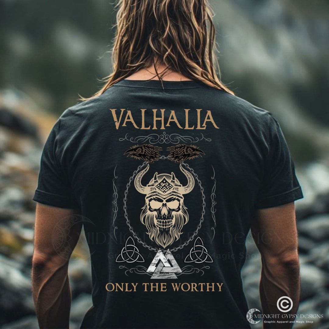 Young muscular Viking man standing outside wearing a black Valhalla Viking Warrior Shirt that says Valhalla Only the Worthy with a Viking skull and Valknut symbol created by Viking apparel company Midnight Gypsy Designs as part of their Viking Apparel clothing line. Perfect Odin God of War shirt, black Vikings shirt, Viking Odin shirt, Valhalla warrior shirt, Norse Viking tee, Norse mythology t-shirt, and pagan shirt for men.