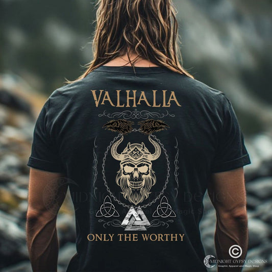 Young muscular Viking man standing outside wearing a black Valhalla Viking Warrior Shirt that says Valhalla Only the Worthy with a Viking skull and Valknut symbol created by Viking apparel company Midnight Gypsy Designs as part of their Viking Apparel clothing line. Perfect Odin God of War shirt, black Vikings shirt, Viking Odin shirt, Valhalla warrior shirt, Norse Viking tee, Norse mythology t-shirt, and pagan shirt for men.