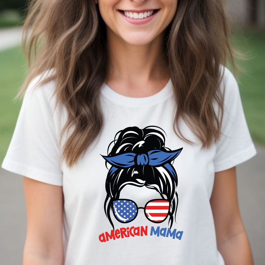 Young American woman with long brown hair smiling while wearing a vintage white American Mama t-shirt with patriotic sunglasses and messy bun created by Patriotic apparel shop Midnight Gypsy Designs.