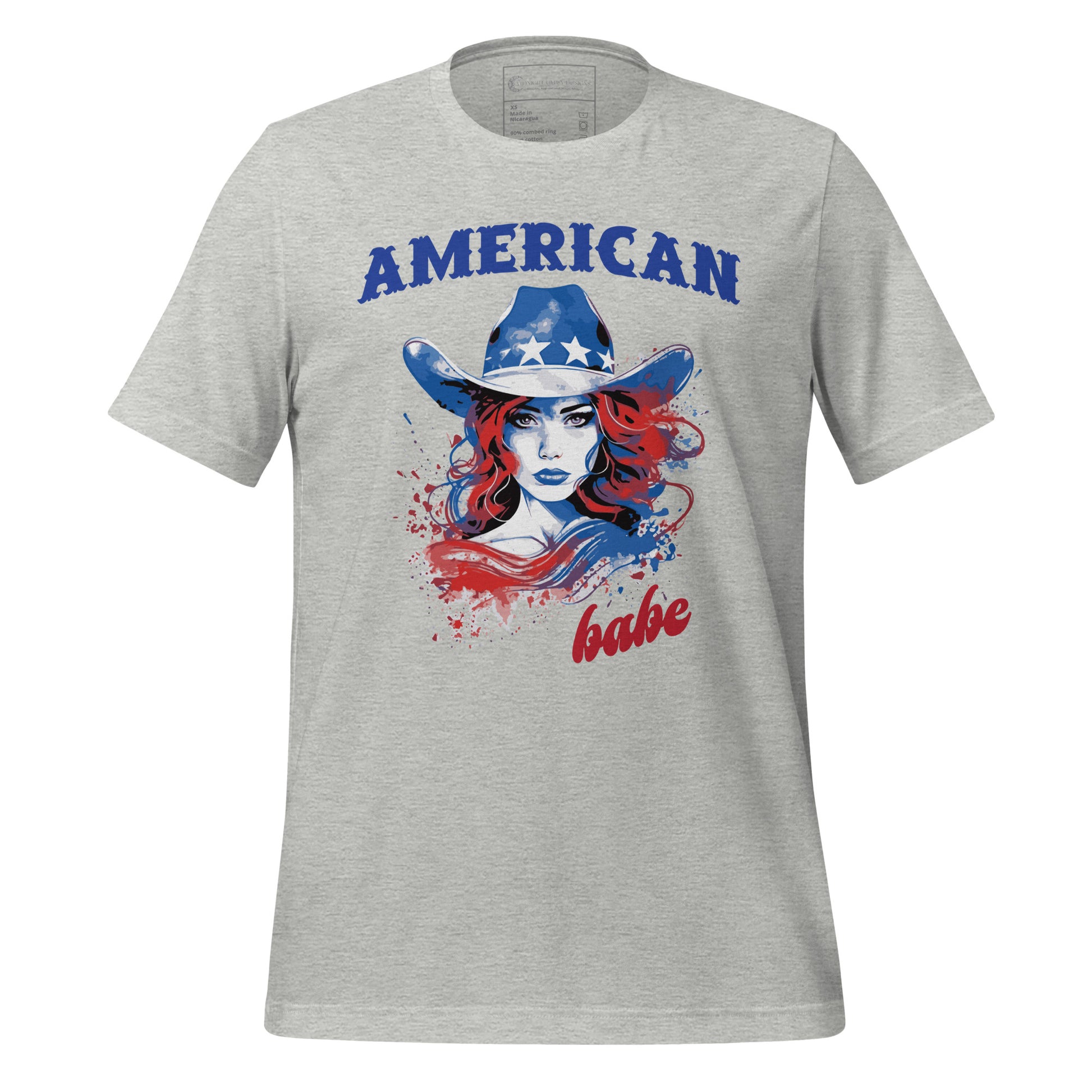A grey Western American Babe shirt that has a woman in a blue cowboy hat with white stars. Created by graphic apparel company Midnight Gypsy Designs as part of their patriotic apparel clothing line. Perfect USA patriotic shirt, fourth of July shirt for women, and American pride shirt.