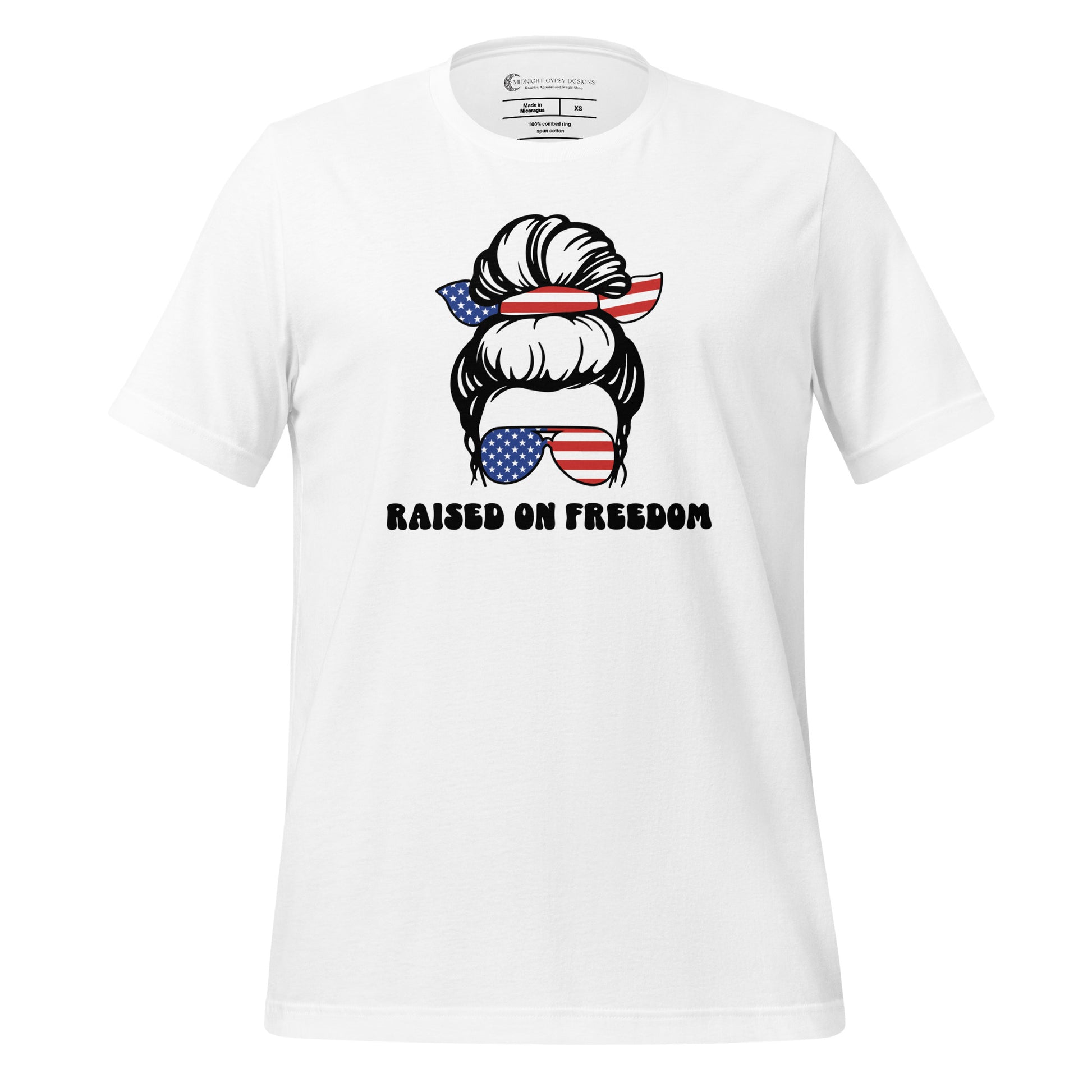 White Raised on Freedom shirt with graphic of a woman with an American flag hair tie and sunglasses created by graphic apparel company Midnight Gypsy Designs as part of their patriotic apparel collection. Perfect USA patriotic shirt, All American Girl shirt, girl power shirt, American pride shirt, USA shirt, USA flag shirt, womens patriotic shirt, Fourth of July shirt, Patriotic pride shirt, American flag shirt, Independence Day shirt, & American girl shirt.